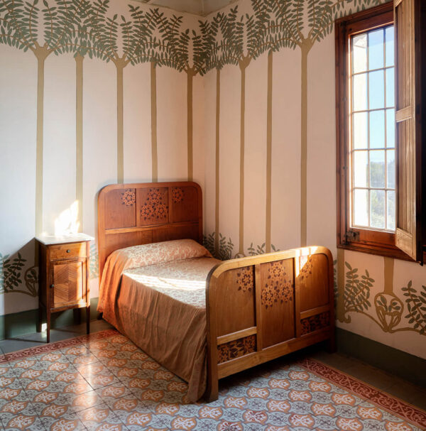 Mark Luscombe-Whyte, nobody, Spanish, interior, indoors, Lluís Domènech i Montaner, art nouveau, modernist, bedroom, guest room, colour, green, neutral, ceiling, recessed ceiling, coffered ceiling, flooring, tiled floor, bed, single bed, headboard, footboard, wood, marquetry, table, bedside table, storage, cabinet, soft furnishing, bedding, bed linen, artwork, hand-painted, mural, floral, pattern, simple, bespoke, craftsmanship, vintage, creativity, individuality, innovation, inspiration,