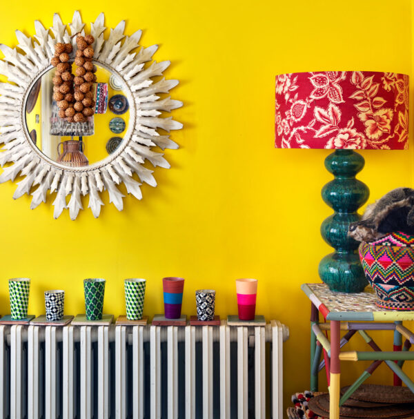 Simon Brown, Lucinda Chambers, indoors, interior, nobody, kitchen, heating, radiator, mirror, lighting, lamp, lampshade, table, side table, painted, collection, display, beaker, wall light, close up, colour, yellow, pattern, floral, English
